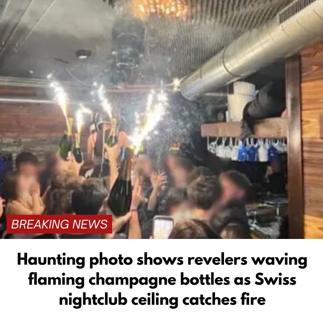 Haunting photo shows revelers waving flaming champagne bottles as Swiss nightclub ceiling catches fire